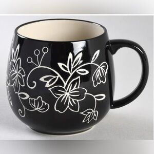 Temp-Tations Floral Lace black mug with a brown handle.